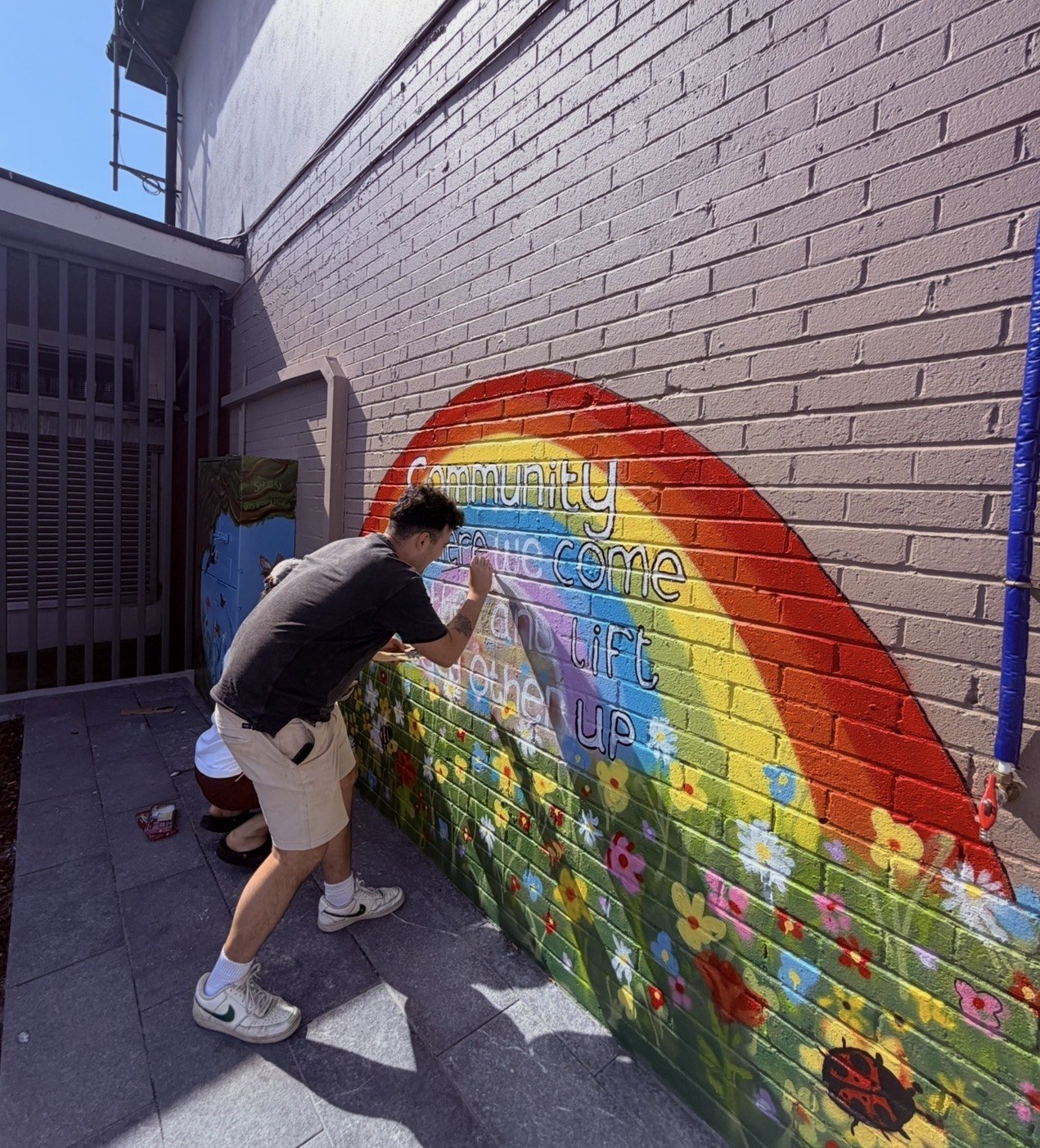 Barry Heneghan painting a community mural